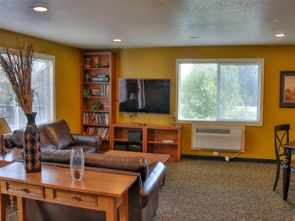 a living room with leather furniture and a tv