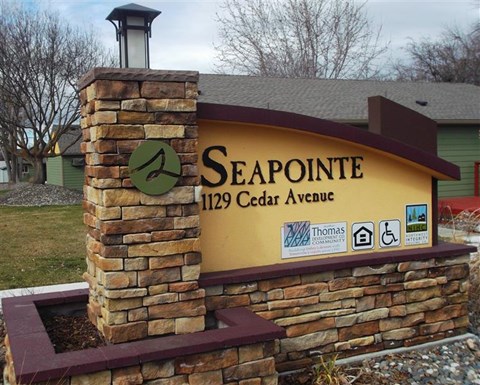 a sign for seapoint 112 cedar avenue in front of a building