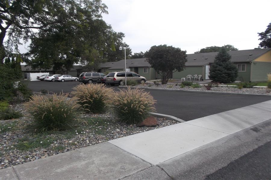 a street with cars parked in front of houses
