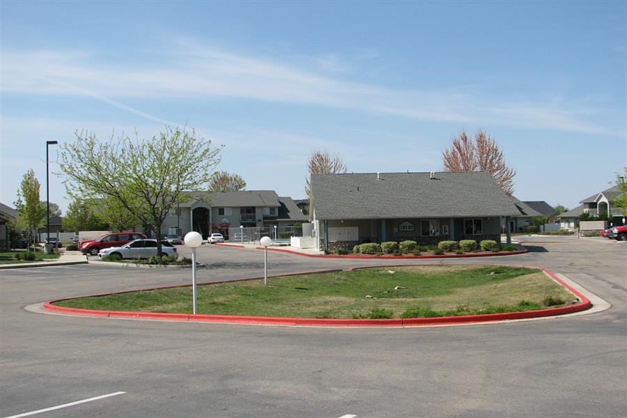 an empty parking lot in front of a house