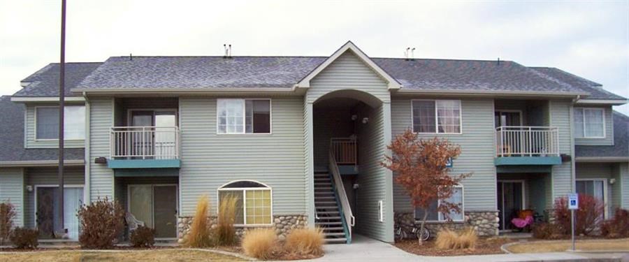 a green house with a porch and a