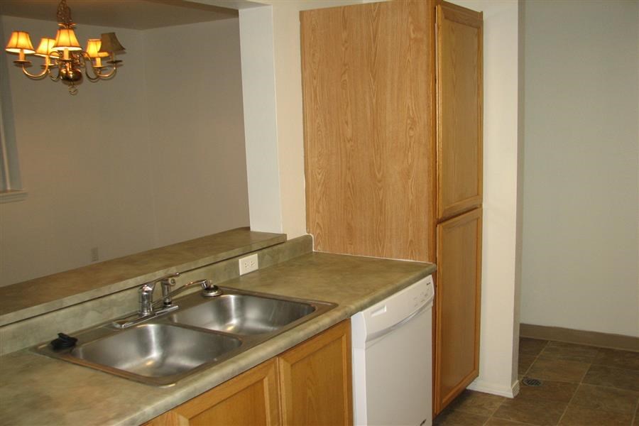a kitchen with a sink and a refrigerator