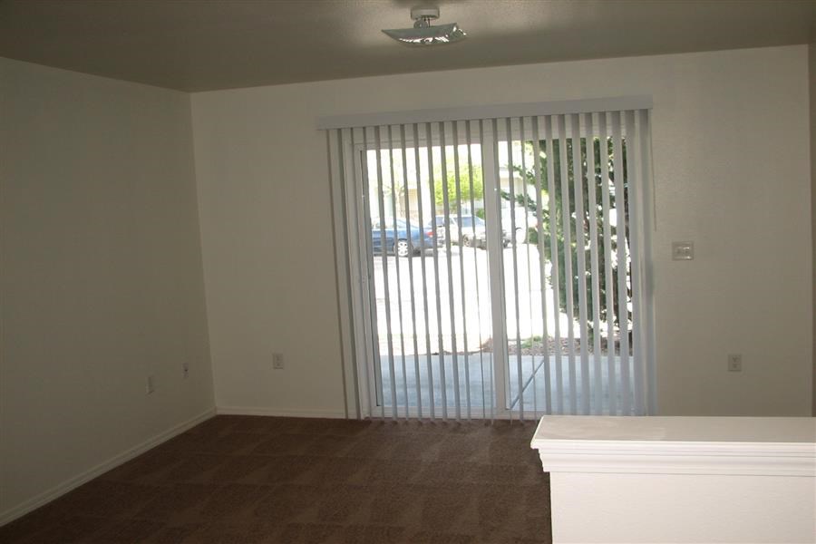 an empty living room with a sliding glass door