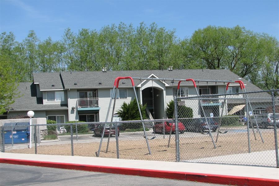 a playground with a house in the background