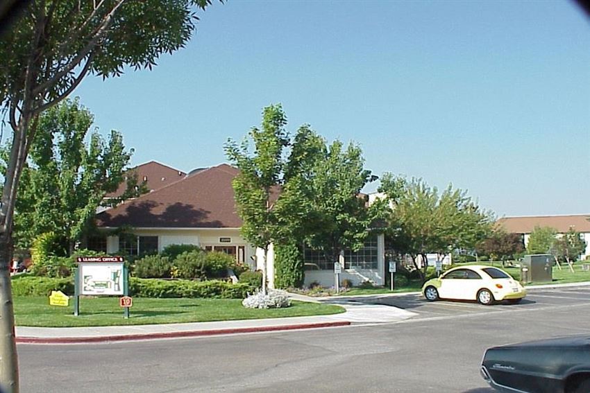 a car parked in a parking lot in front of a house