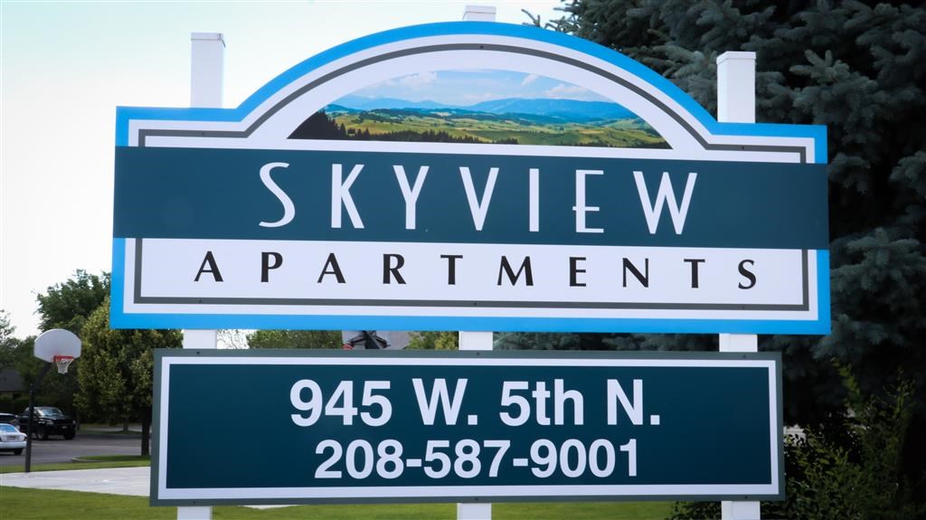 a sign apartments with a view of the mountains