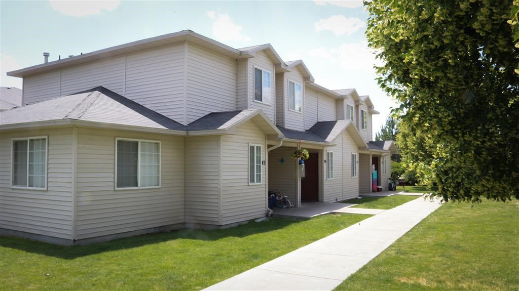 a white house with a sidewalk in front of it
