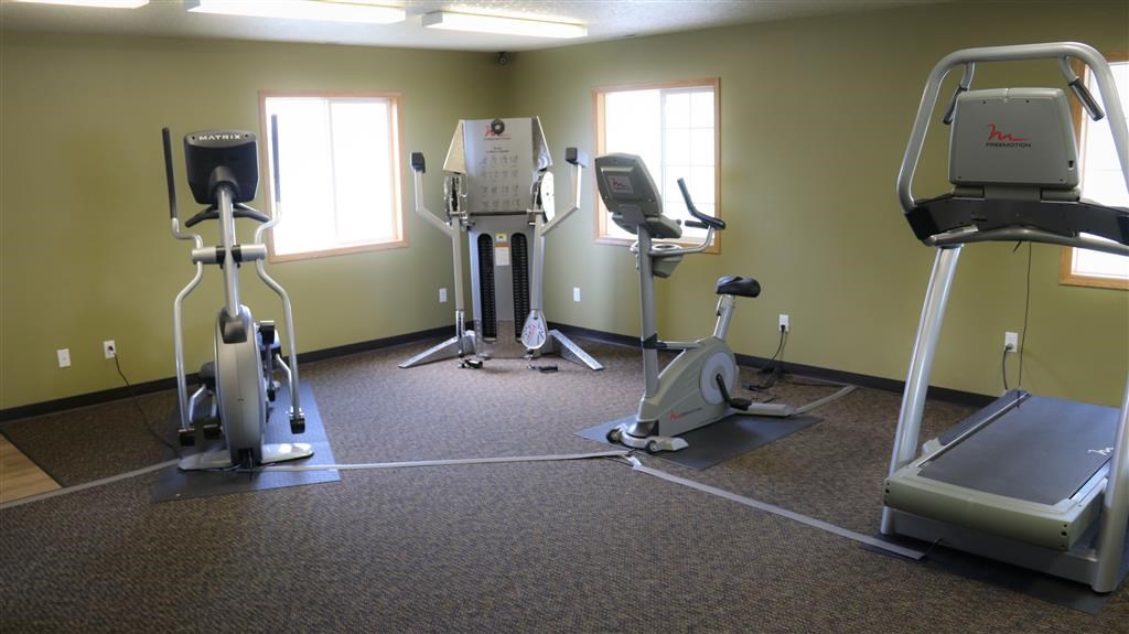 a gym with various exercise equipment in a room