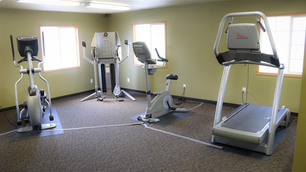 a gym with various exercise equipment in a room