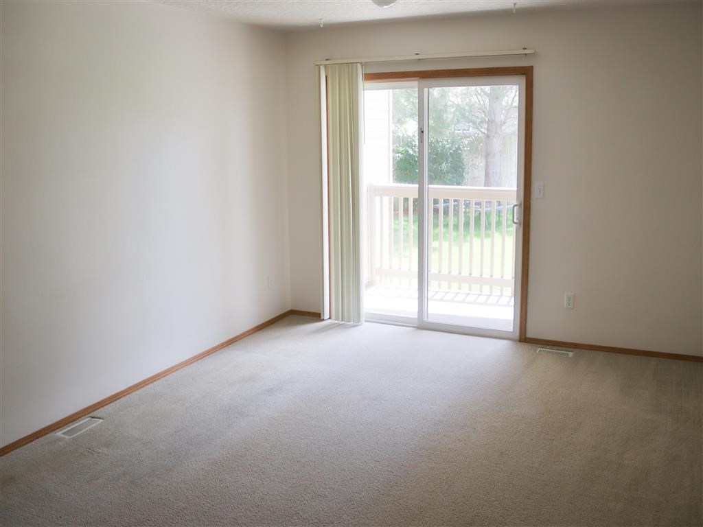 an empty living room with a sliding glass door