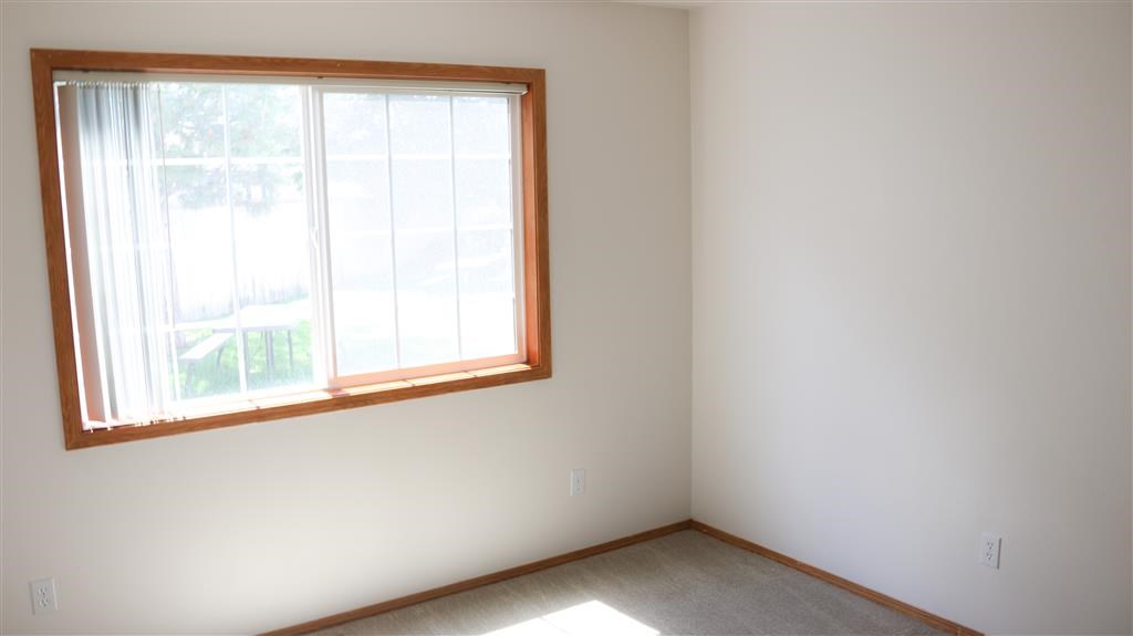 a room with a large window and a carpet