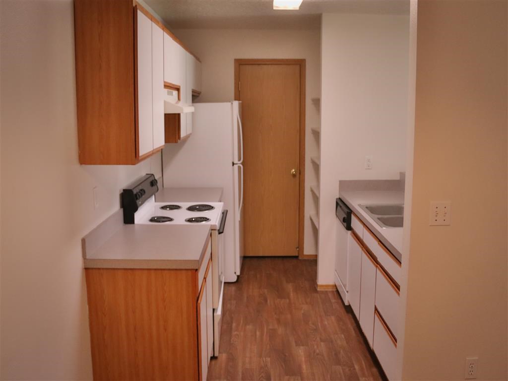 a kitchen with a stove and a refrigerator