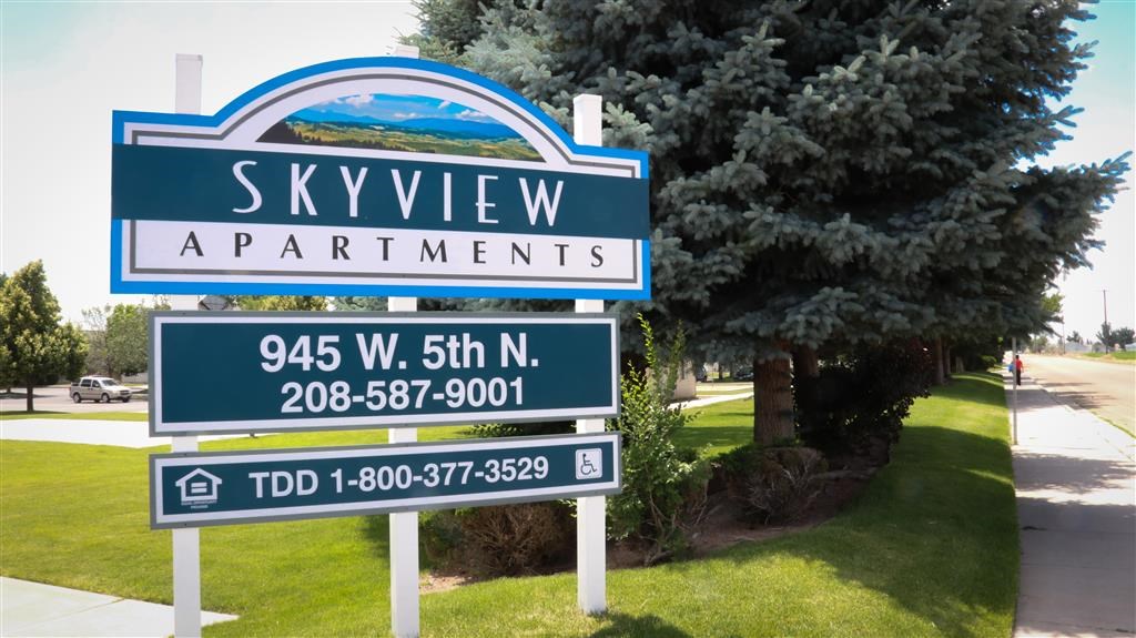 a sign apartments on the side of a road