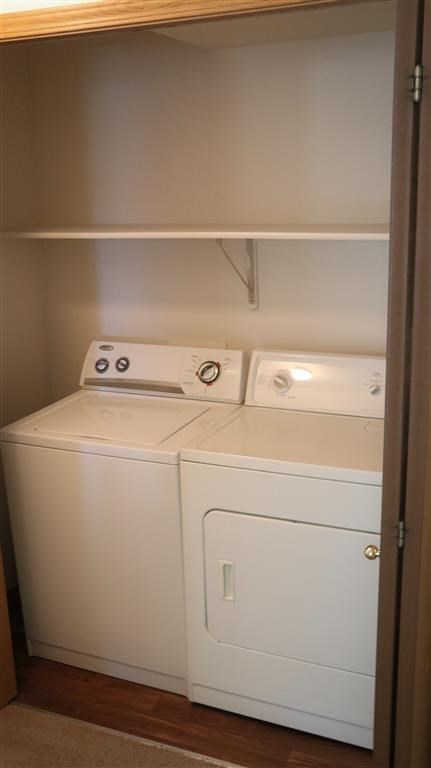 a white washer and dryer in a small room