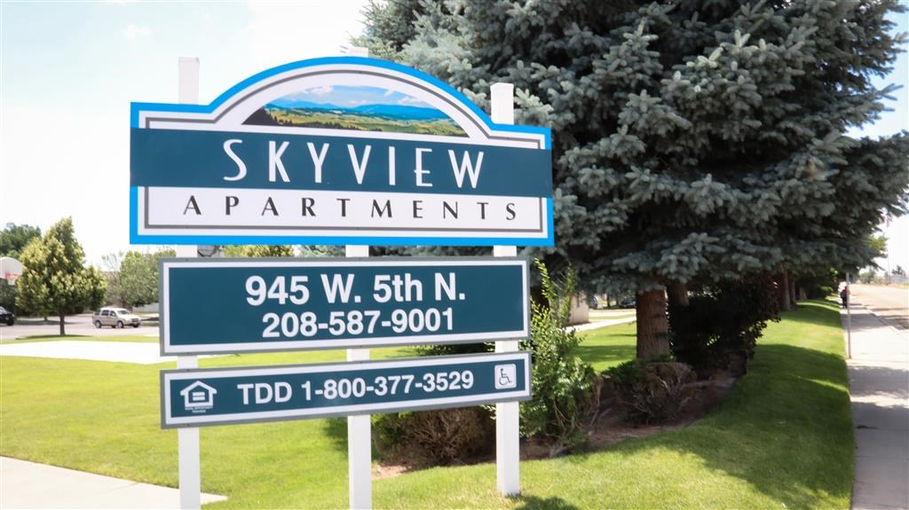 a sign apartments on the side of a road