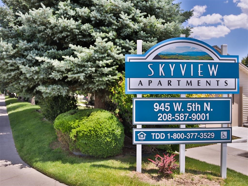 a sign apartments on the side of a street