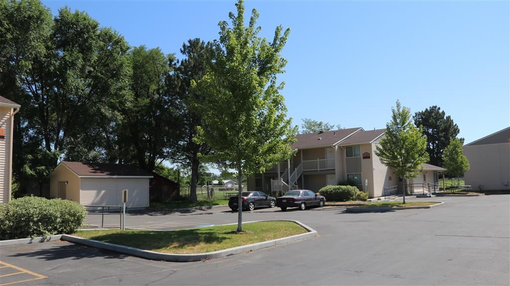 a street with cars parked in front of houses