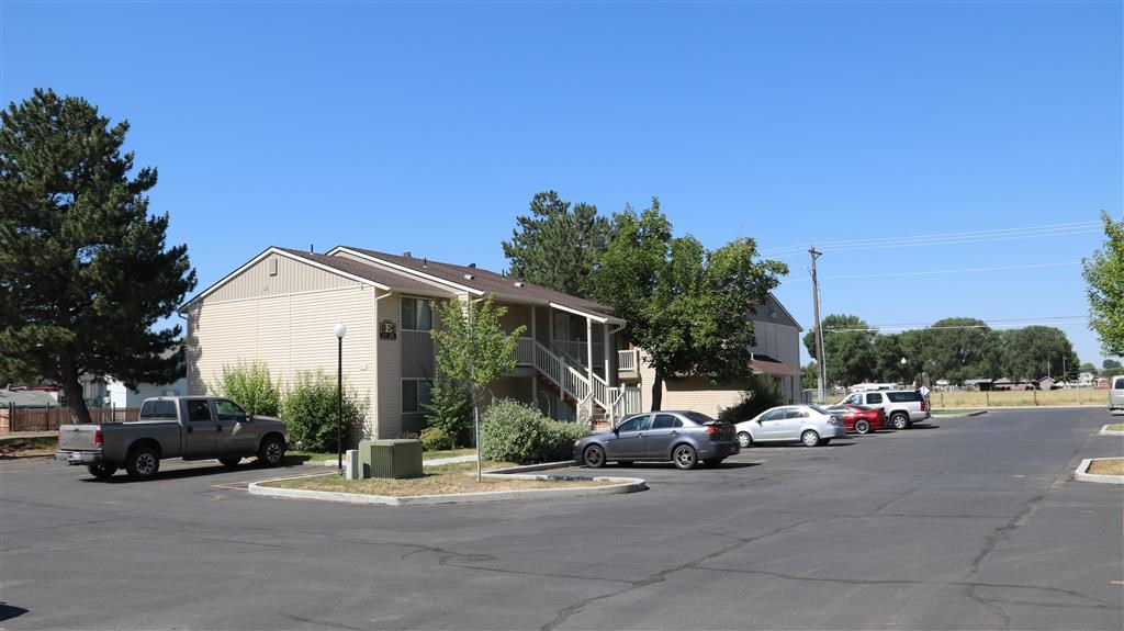 a street with cars parked in front of houses