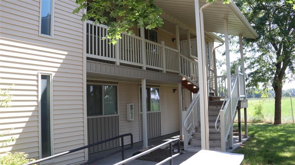 a white house with a porch and stairs
