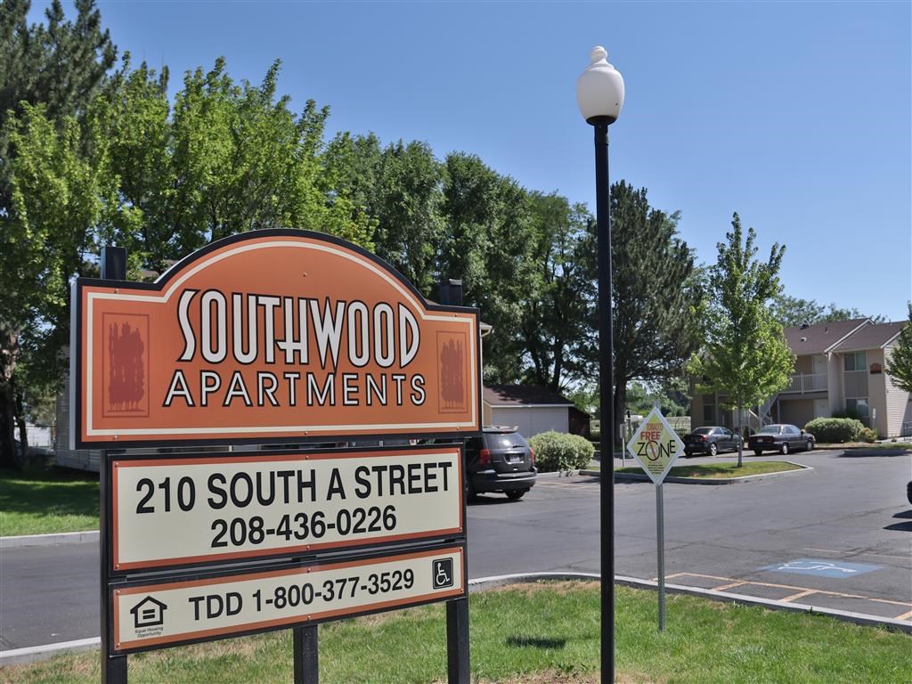 a sign for southwood apartments in a parking lot