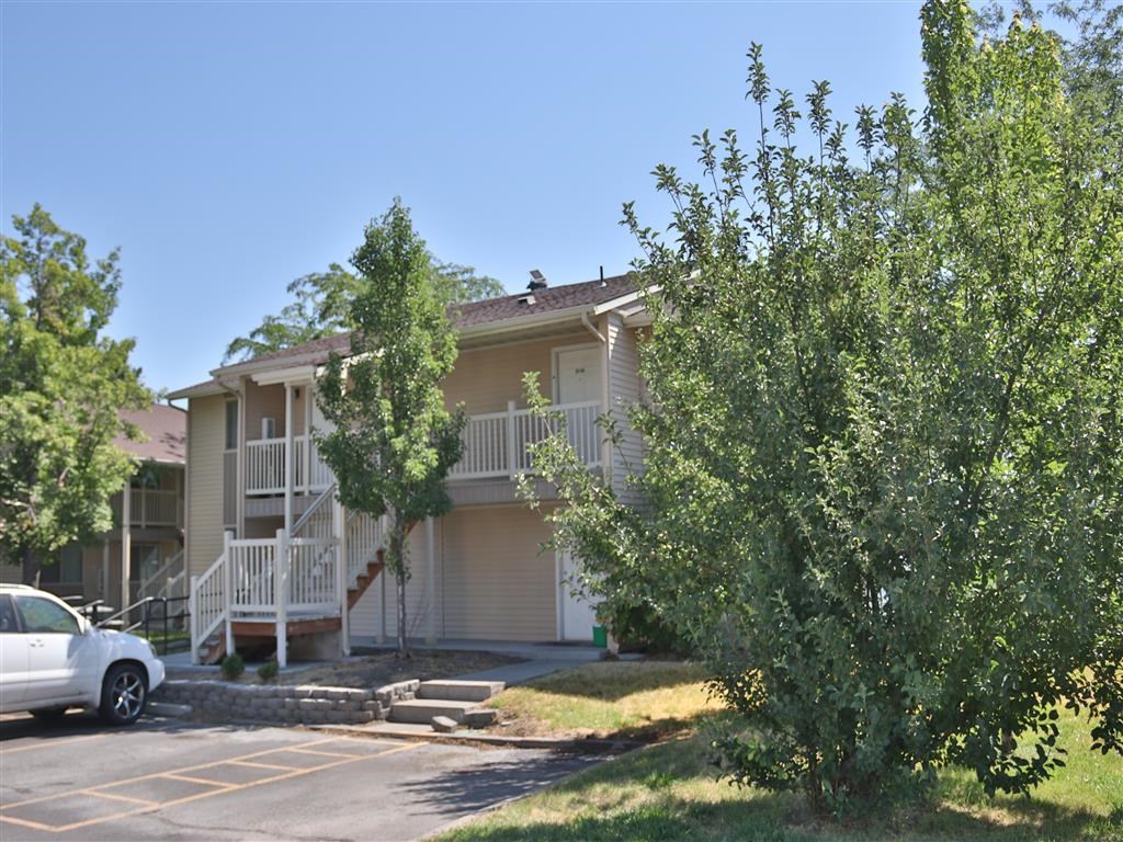 an apartment building with a car parked in front of it