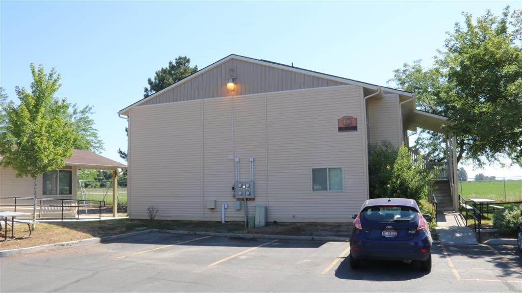a car parked in a parking lot in front of a building