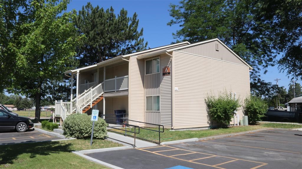 an apartment building with a parking lot and stairs