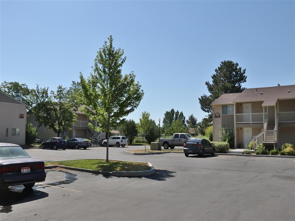 an empty parking lot in front of an apartment building