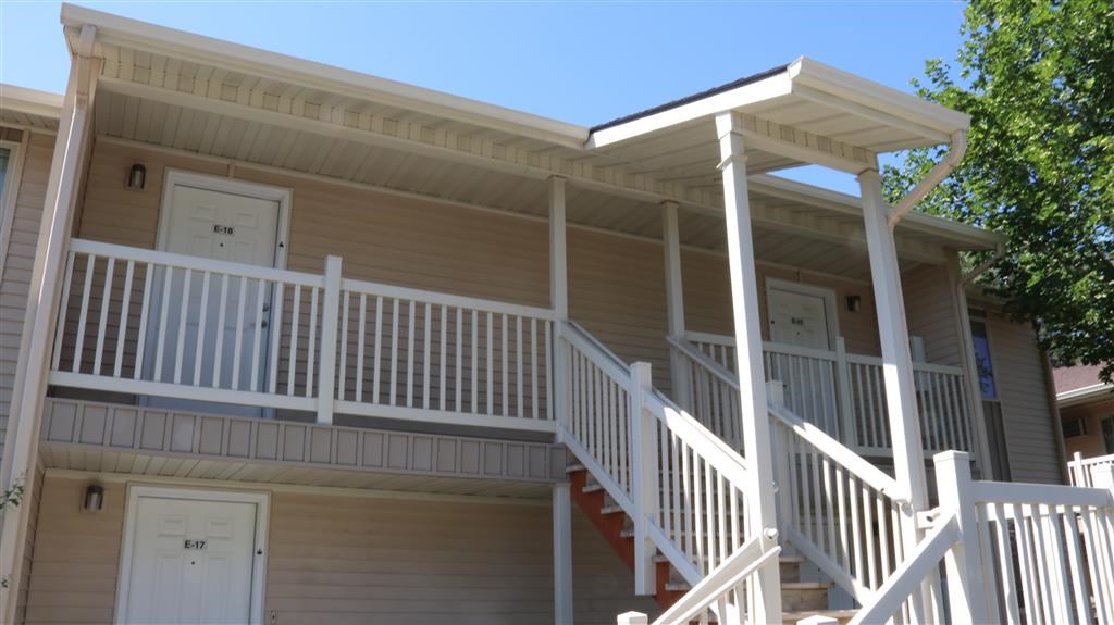 an exterior view of a house with stairs and a porch