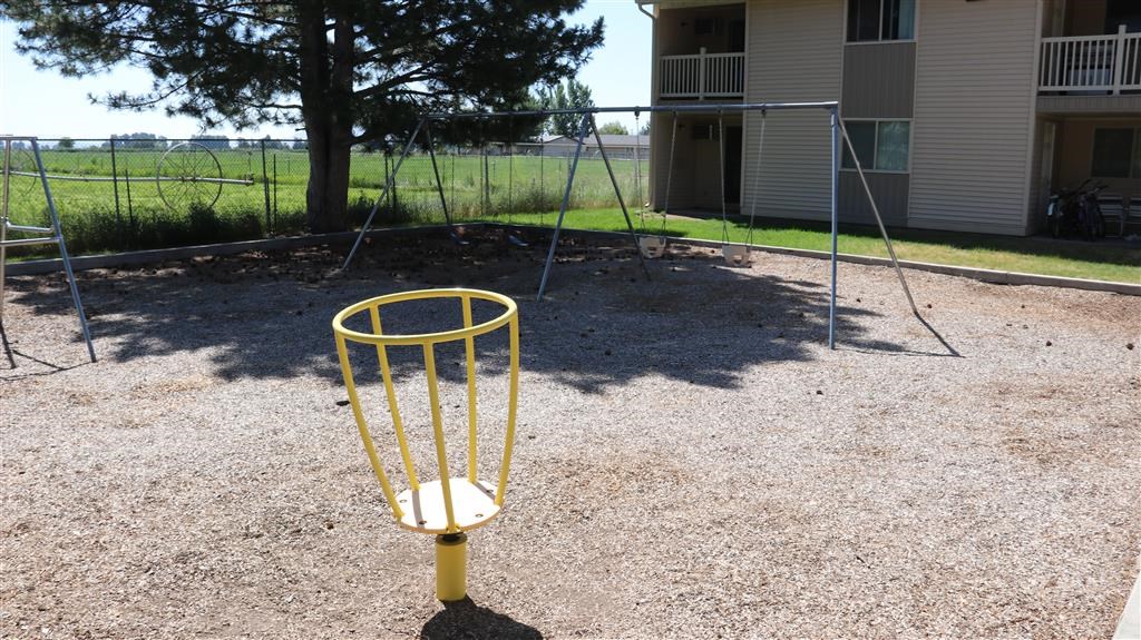 a yellow frisbee cage in a park