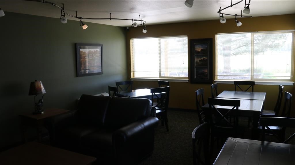 a living room with leather furniture and a table and chairs