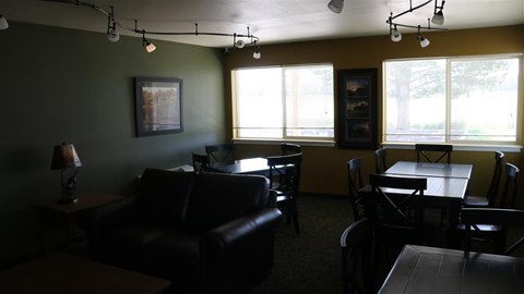 a living room with leather furniture and a table and chairs