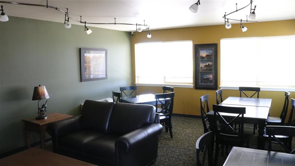 a living room with leather furniture and a table and chairs