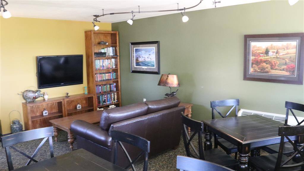 a living room with leather furniture and a television