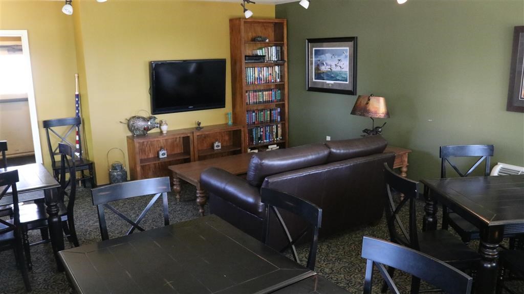 a living room with leather furniture and a television