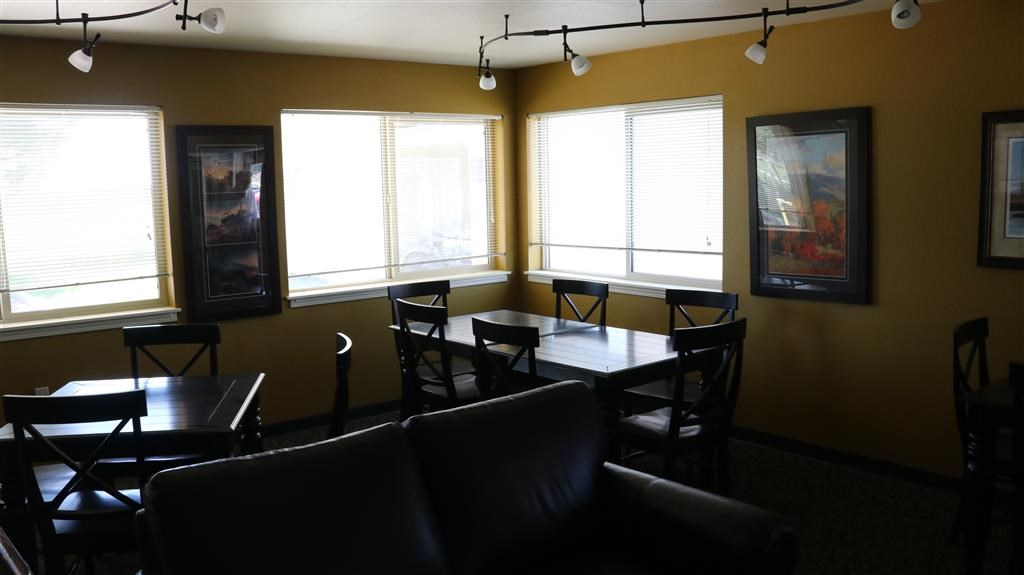 a dining room with tables and chairs and windows
