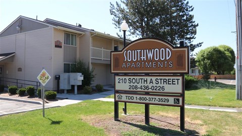 a sign for southwood apartments in front of a building