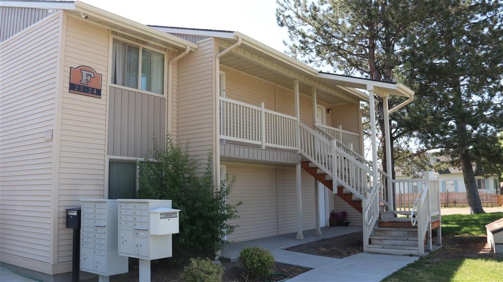 an apartment building with a staircase and mailboxes