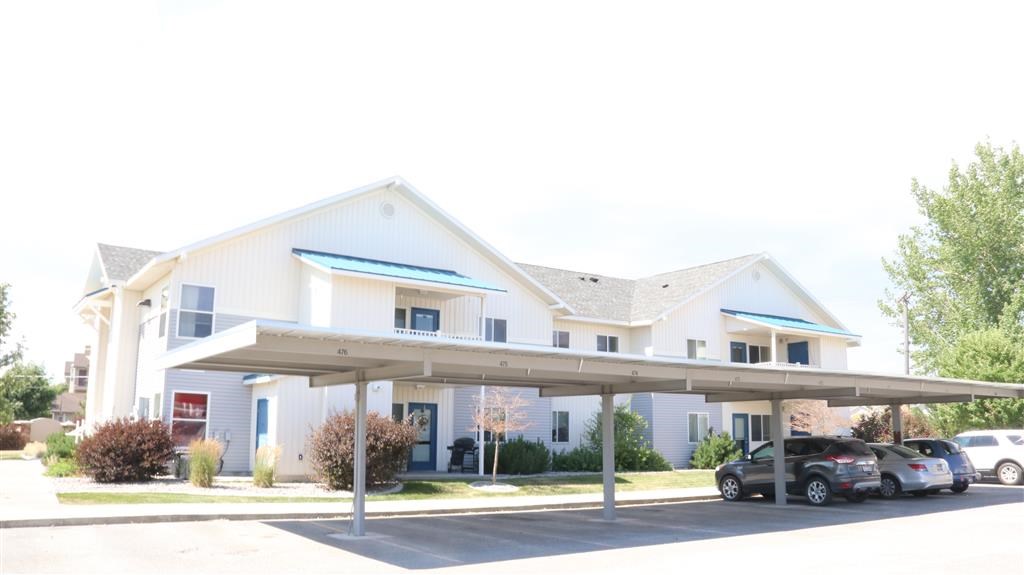 a white house with cars parked in front of it