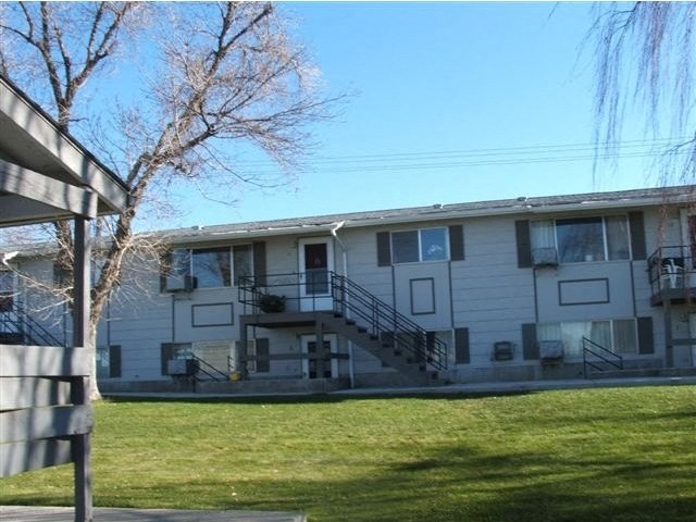 a white building with a lawn in front of it