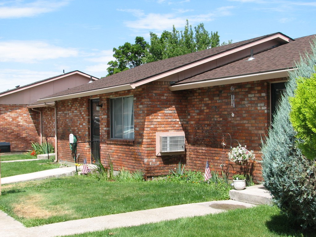 a brick house with a lawn in front of it