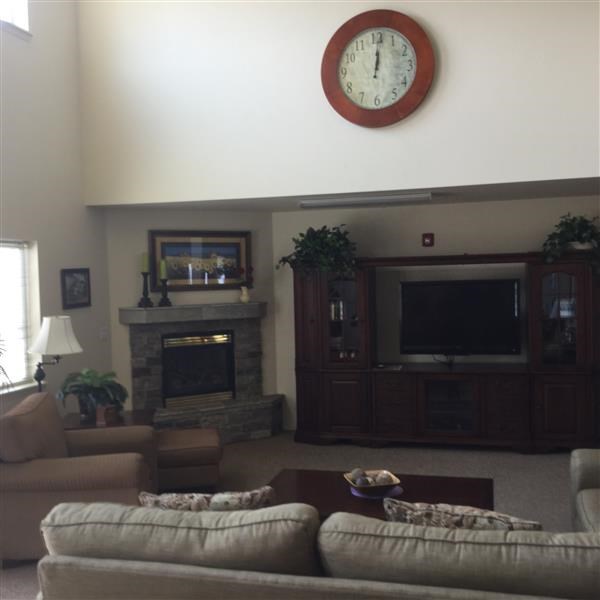 a living room with a couch and a clock on the wall