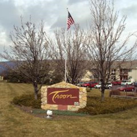a sign for a restaurant in front of a flag