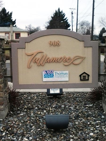 a sign in front of a building on the gravel