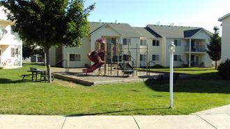 the playground is in front of some houses