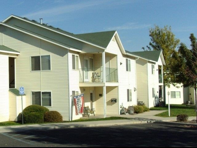 a row of houses with a street in front of them