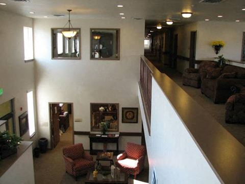 a lobby with couches and chairs and a staircase