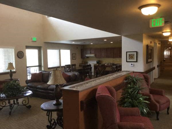 a living room with couches and a bar