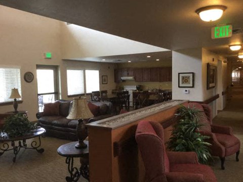 a living room with couches and a bar