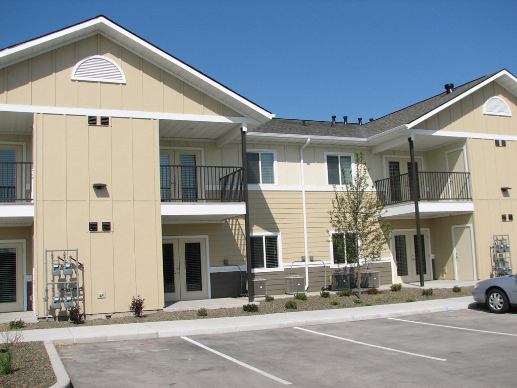 a parking lot in front of an apartment building